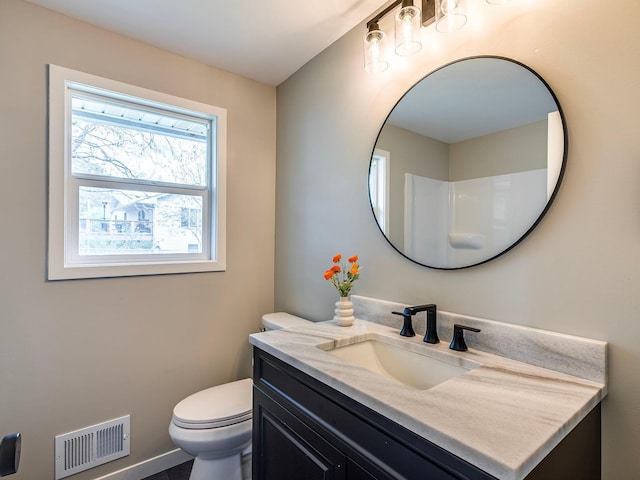 bathroom featuring toilet, baseboards, visible vents, and vanity