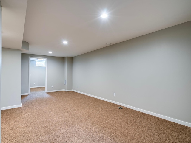 empty room featuring carpet floors, baseboards, and recessed lighting