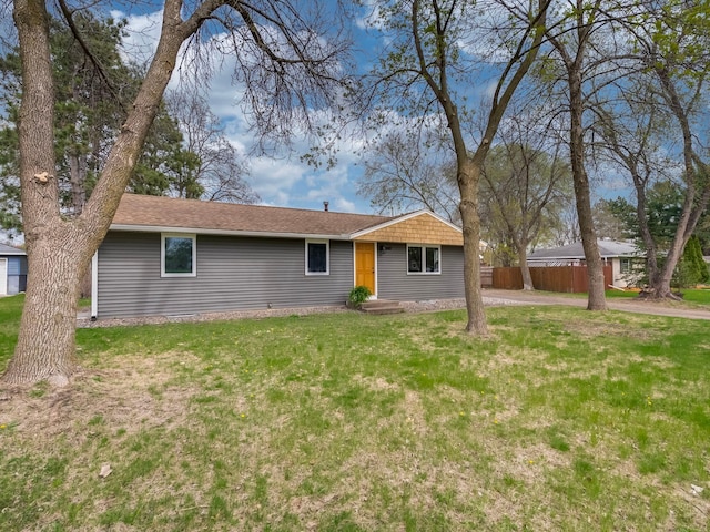 single story home featuring a front lawn and fence