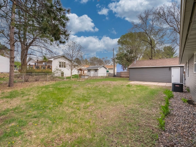 view of yard with fence and central AC