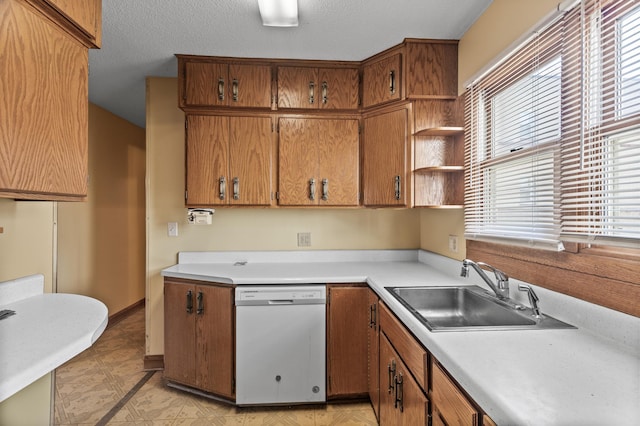 kitchen with light countertops, white dishwasher, brown cabinets, and a sink