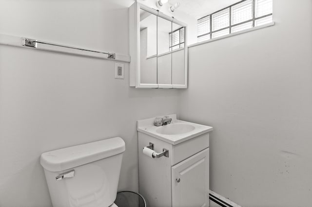 half bathroom featuring vanity and toilet