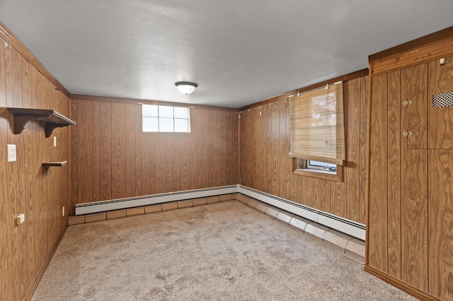 basement with carpet flooring, wood walls, and a baseboard radiator