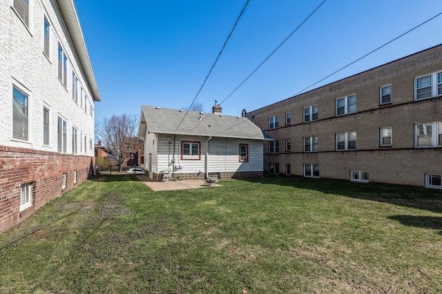 rear view of property featuring a yard