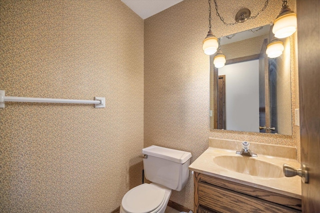 bathroom with toilet and vanity