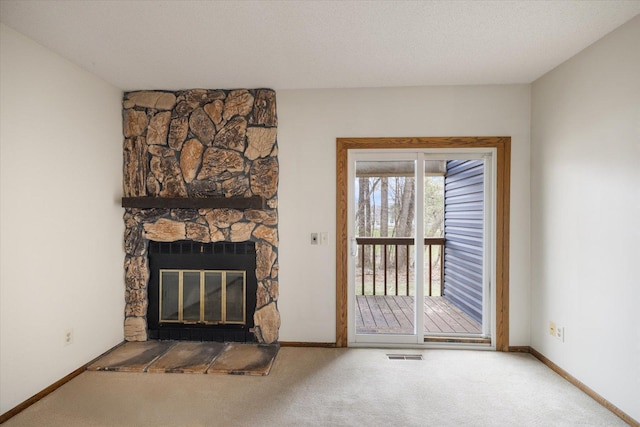 unfurnished living room with baseboards, carpet, and visible vents