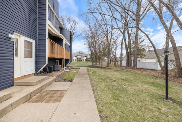 view of yard with fence and cooling unit