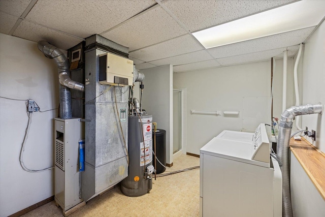interior space featuring heating unit, washer and dryer, baseboards, light floors, and gas water heater