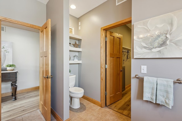 bathroom with baseboards, tile patterned flooring, toilet, and visible vents