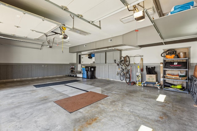 garage featuring a garage door opener and wainscoting