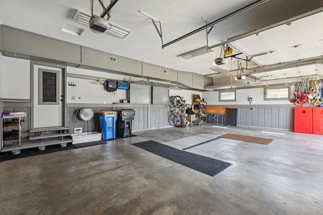 garage featuring visible vents and a garage door opener