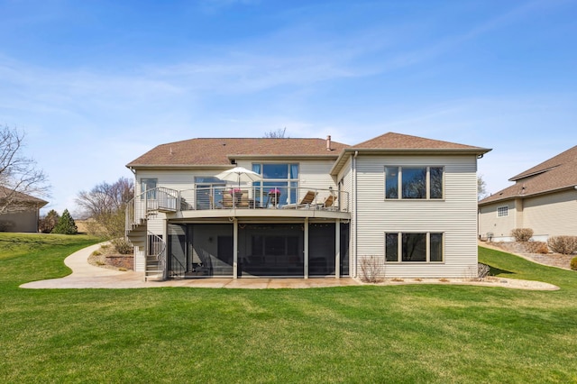 back of house featuring a sunroom, a wooden deck, a yard, and stairway