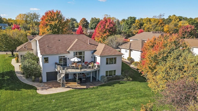 back of property with a patio, a lawn, a wooden deck, and stairs