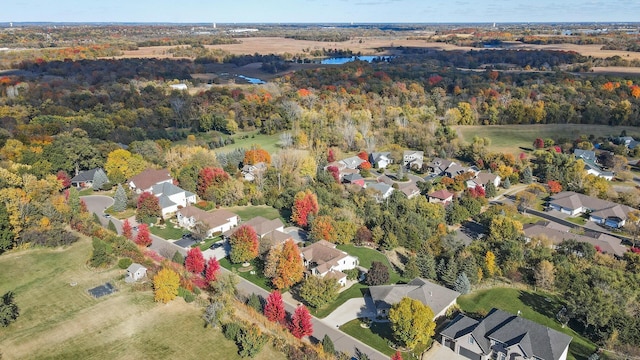 birds eye view of property featuring a water view, a residential view, and a forest view