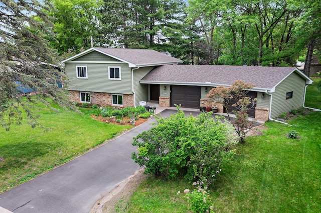 216 Richard Ave SE, Isanti, MN 55040 - split level home with a garage, brick siding, driveway, and a front lawn