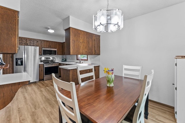 216 Richard Ave SE, Isanti, MN 55040 - dining area with light wood finished floors and a chandelier