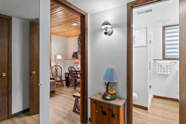 216 Richard Ave SE, Isanti, MN 55040 - hall with light wood finished floors, baseboards, and a textured ceiling