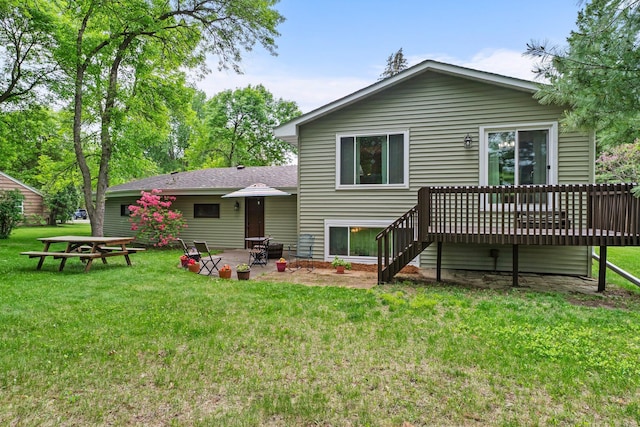 216 Richard Ave SE, Isanti, MN 55040 - back of house featuring a deck, a patio, a lawn, and stairs