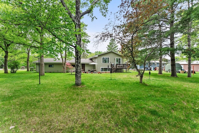 216 Richard Ave SE, Isanti, MN 55040 - view of grassy yard with a wooden deck