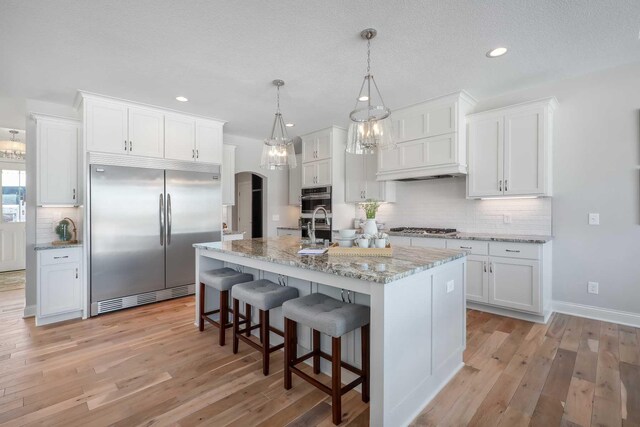 3175 Winfield Way SW, Prior Lake, MN 55372 - kitchen featuring stainless steel appliances, arched walkways, recessed lighting, and white cabinetry