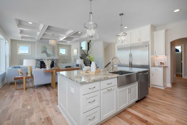 3175 Winfield Way SW, Prior Lake, MN 55372 - kitchen with appliances with stainless steel finishes, a sink, light wood finished floors, open floor plan, and recessed lighting