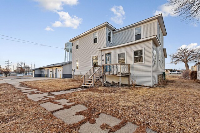 107 6th Ave SE, Waseca, MN 56093 - rear view of property with driveway, an outbuilding, and a deck