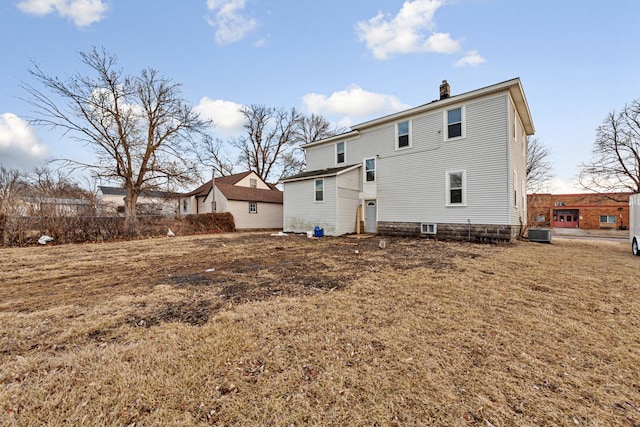 107 6th Ave SE, Waseca, MN 56093 - back of house with a yard, central AC, and a chimney