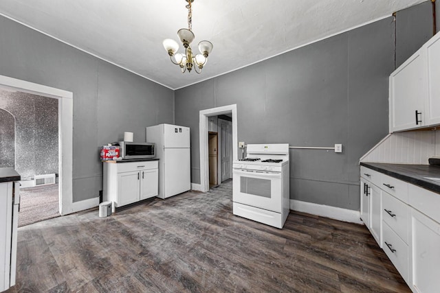 107 6th Ave SE, Waseca, MN 56093 - kitchen with visible vents, dark countertops, white appliances, dark wood finished floors, and a notable chandelier