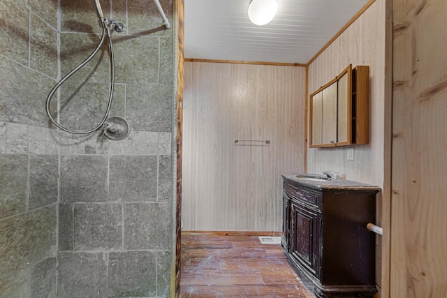 107 6th Ave SE, Waseca, MN 56093 - bathroom with vanity, a wood stove, and tiled shower