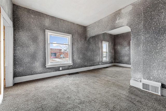 107 6th Ave SE, Waseca, MN 56093 - carpeted spare room featuring visible vents and arched walkways