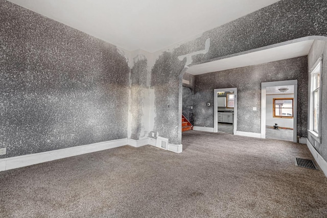 107 6th Ave SE, Waseca, MN 56093 - unfurnished room featuring visible vents, carpet, and stairs