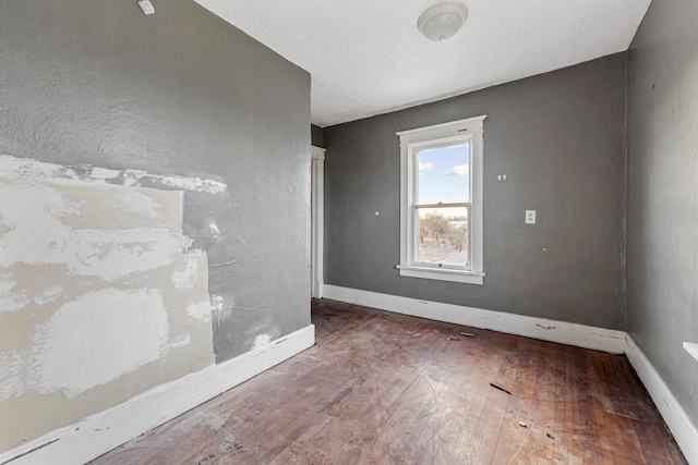 107 6th Ave SE, Waseca, MN 56093 - unfurnished room featuring baseboards and hardwood / wood-style flooring