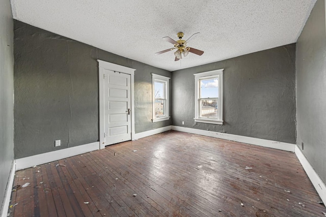 107 6th Ave SE, Waseca, MN 56093 - unfurnished room featuring a textured ceiling, ceiling fan, baseboards, and hardwood / wood-style floors
