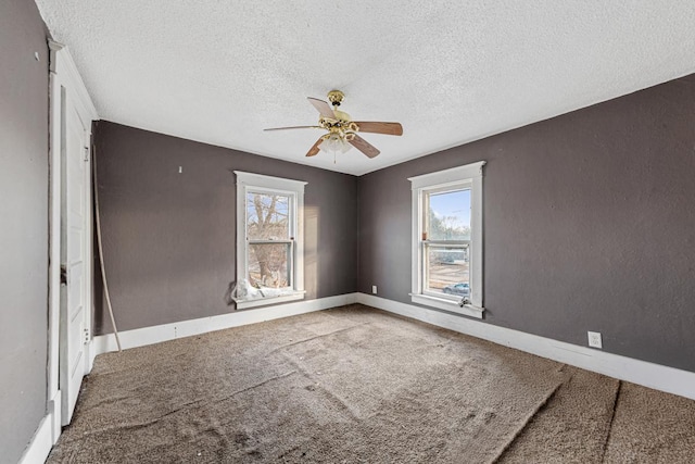 107 6th Ave SE, Waseca, MN 56093 - carpeted empty room with baseboards, a ceiling fan, a textured ceiling, and a healthy amount of sunlight