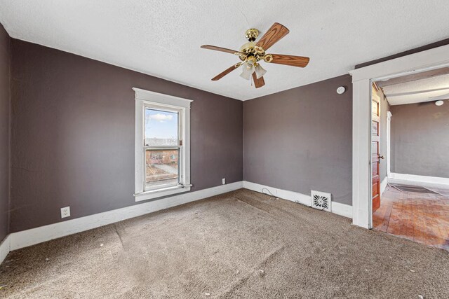 107 6th Ave SE, Waseca, MN 56093 - carpeted spare room featuring visible vents, a textured ceiling, ceiling fan, and baseboards