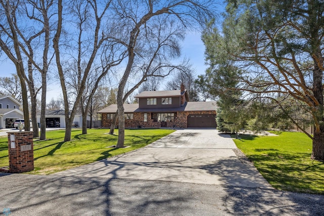 view of front of property featuring driveway, a chimney, a front yard, an attached garage, and stone siding