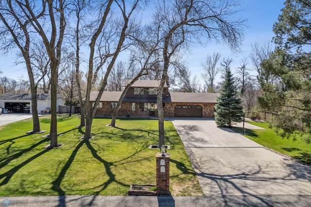 traditional-style house featuring a garage, stone siding, a front yard, and concrete driveway