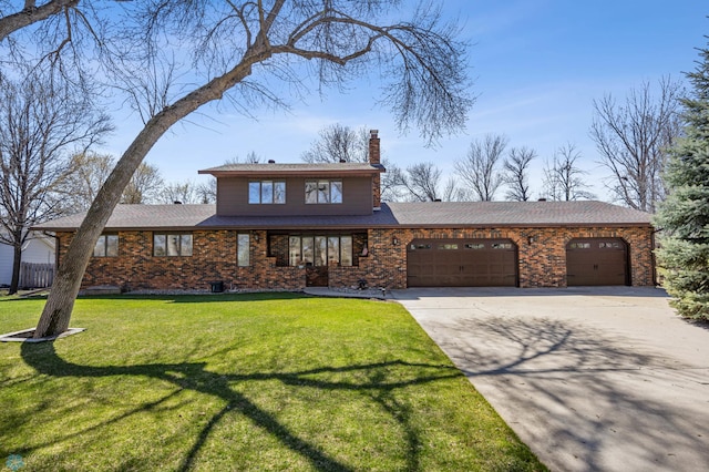 traditional-style house with a chimney, a front yard, brick siding, concrete driveway, and an attached garage