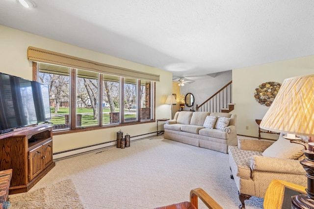 living room with a baseboard radiator, carpet flooring, a baseboard heating unit, and a wealth of natural light