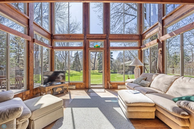 sunroom / solarium with a towering ceiling
