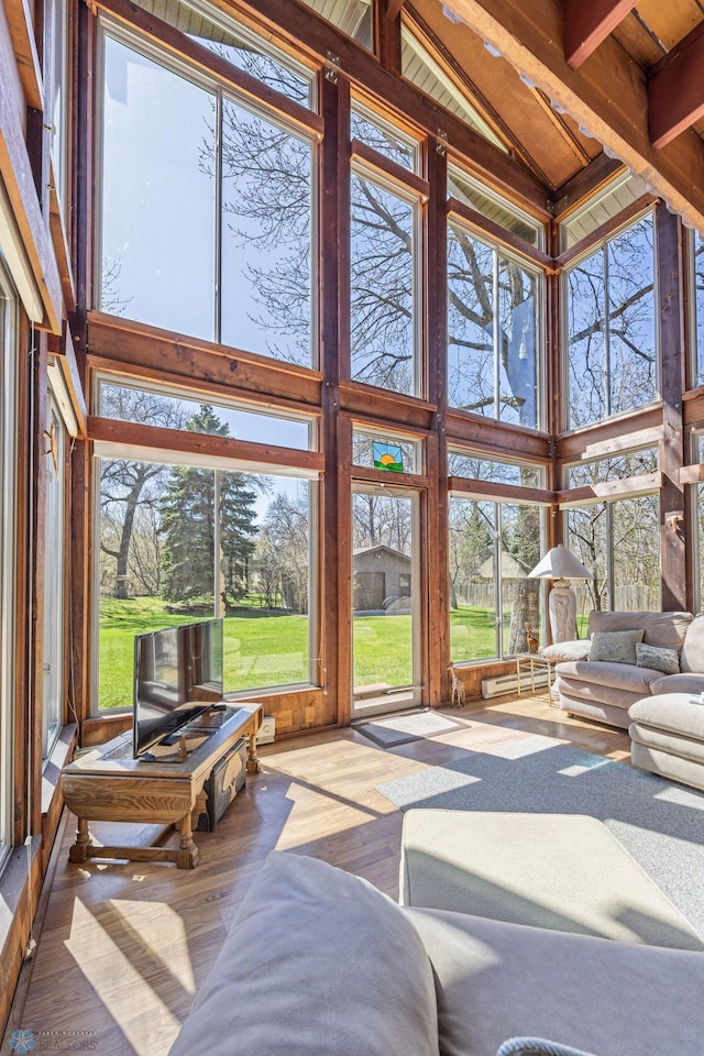 sunroom / solarium featuring beam ceiling