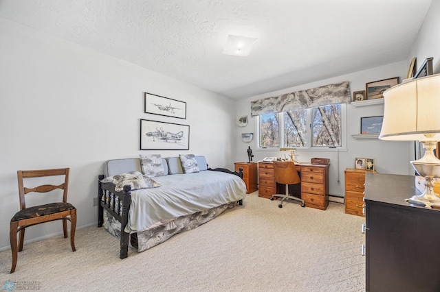 bedroom featuring a baseboard heating unit and light colored carpet