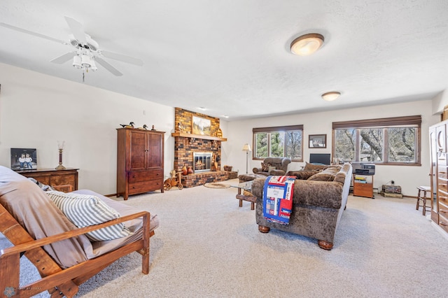 carpeted living room featuring baseboards, a brick fireplace, and ceiling fan