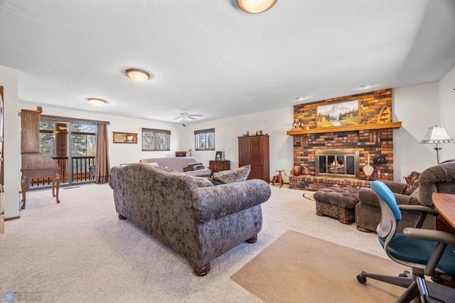 carpeted living area featuring a textured ceiling, a brick fireplace, and ceiling fan