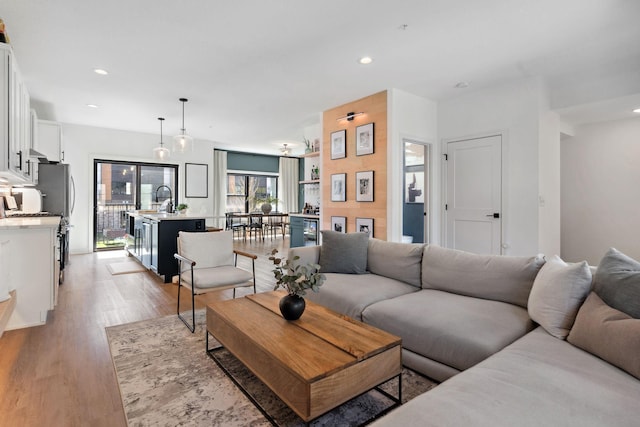 living room with recessed lighting and light wood finished floors