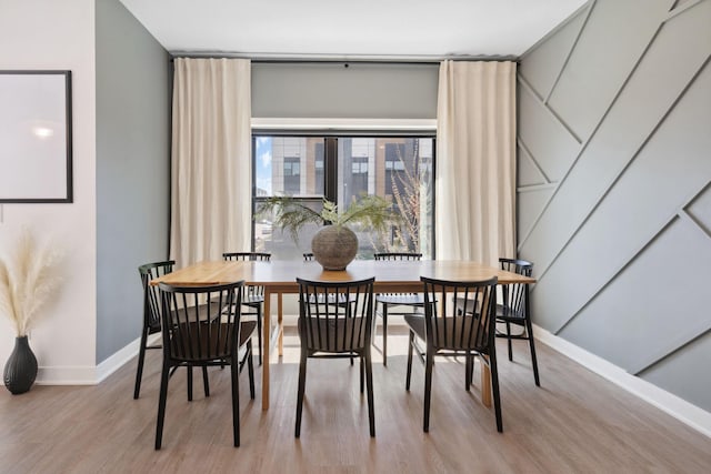dining room featuring baseboards and wood finished floors