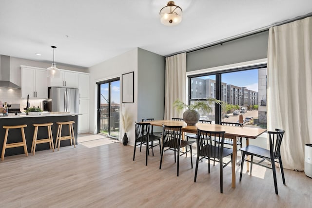 dining room featuring plenty of natural light and light wood-style flooring