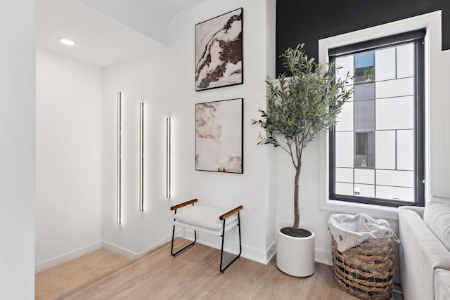 hallway with baseboards and light wood-type flooring