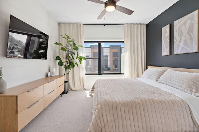 bedroom with ceiling fan and light carpet