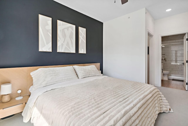 bedroom featuring a ceiling fan and connected bathroom